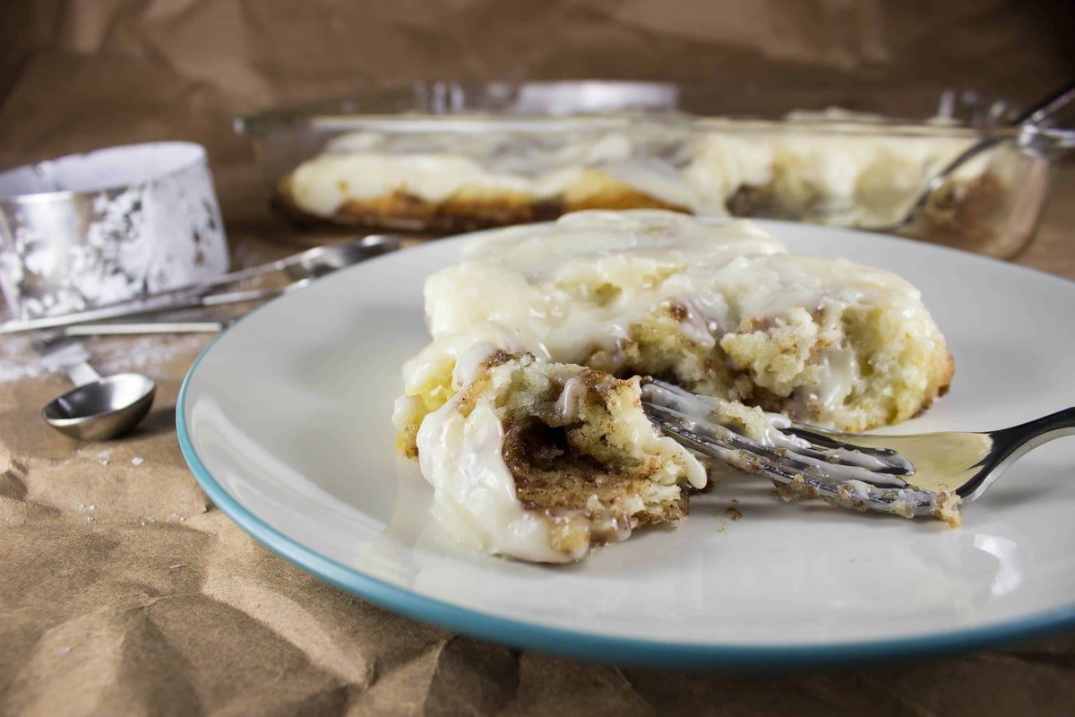 cinnamon roll on plate with fork