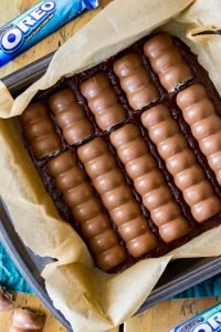 Overhead of oreo mint candy bars placed into brownie batter pan