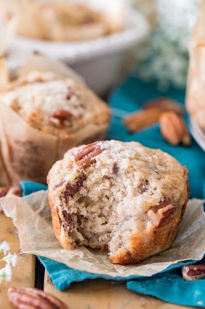 Gourmet BANANA NUT MUFFINS! Made with rich brown butter and nuts, these are so good! #breakfast #muffins Banana Nut Muffin on parchment paper wrapper