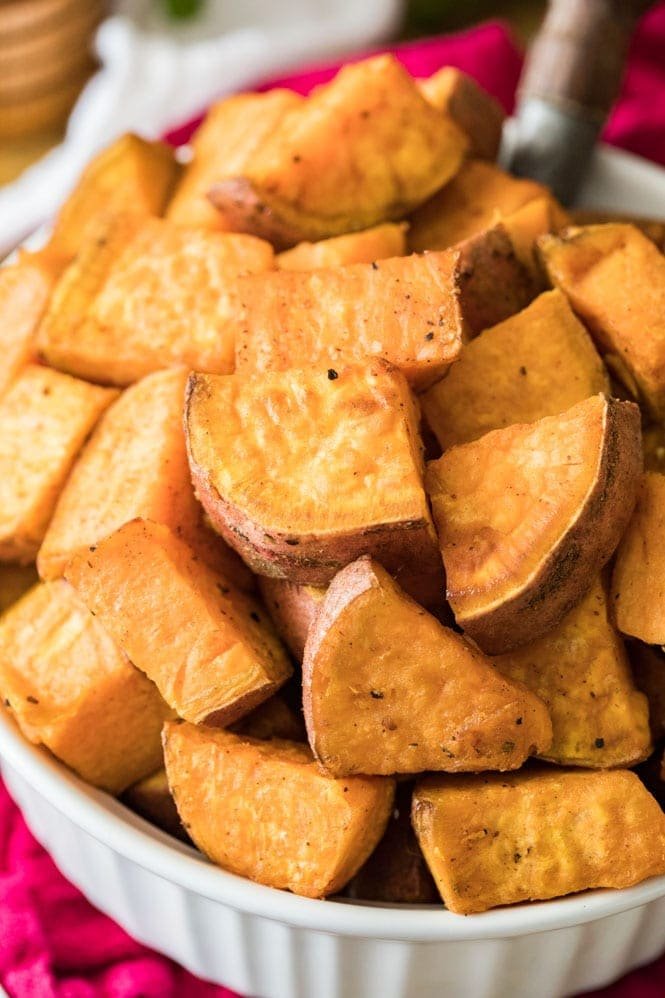 How to make ROASTED SWEET POTATOES! A simple classic recipe. #thanksgivingrecipe #holidayrecipe #sidedish Bowl of roasted sweet potatoes