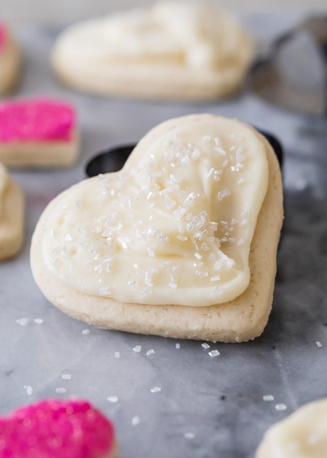How to make CREAM CHEESE SUGAR COOKIES! OMG these are so thick and soft and the cream cheese makes them out of this world! #sugarocokies #cutoutcookies #valentinesdaydesserts Heart shaped cream cheese cookie with cream cheese frosting