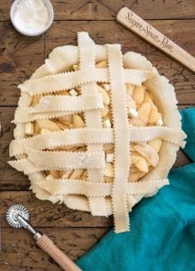 weaving a second vertical strip of pie dough