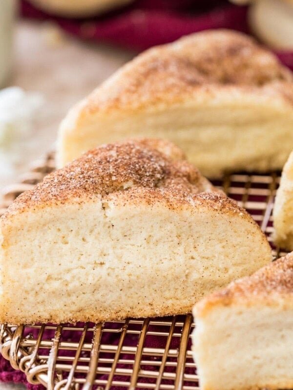 Cinnamon sugar dusted snickerdoodle scones on gold cooling rack