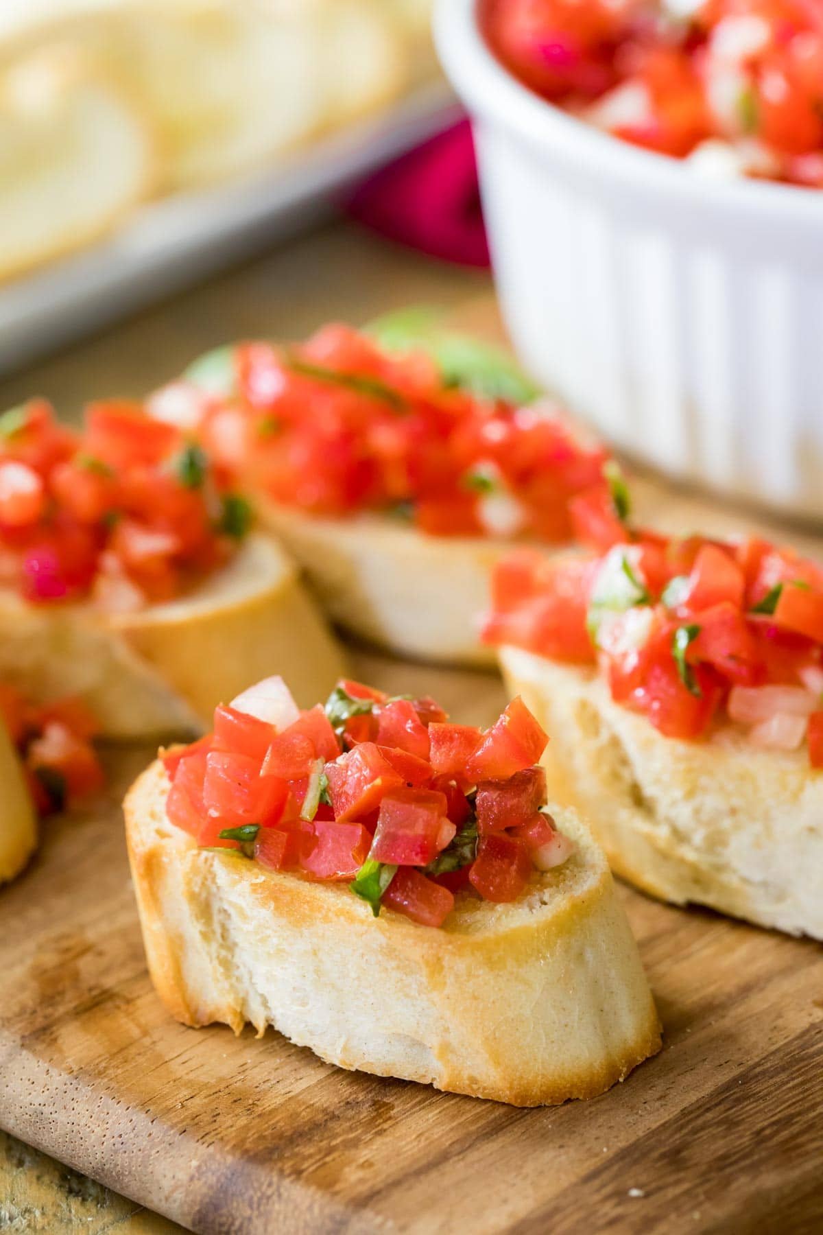 slices of bruschetta topped with chopped marinated tomatoes, basil, and garlic