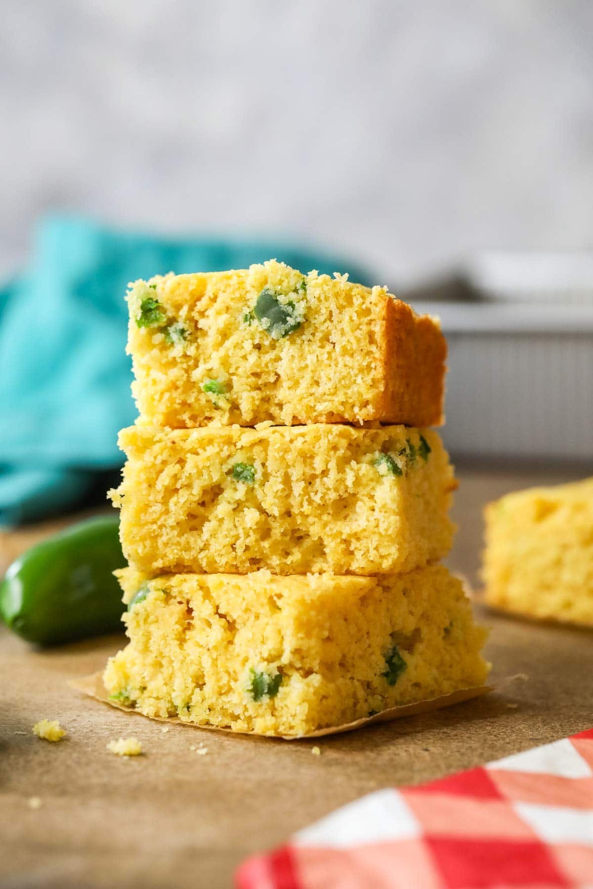 Stack of three pieces of jalapeno cornbread.