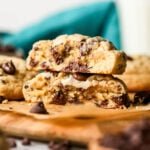 Two halves of thick chocolate chip cookies stacked on top of each other.