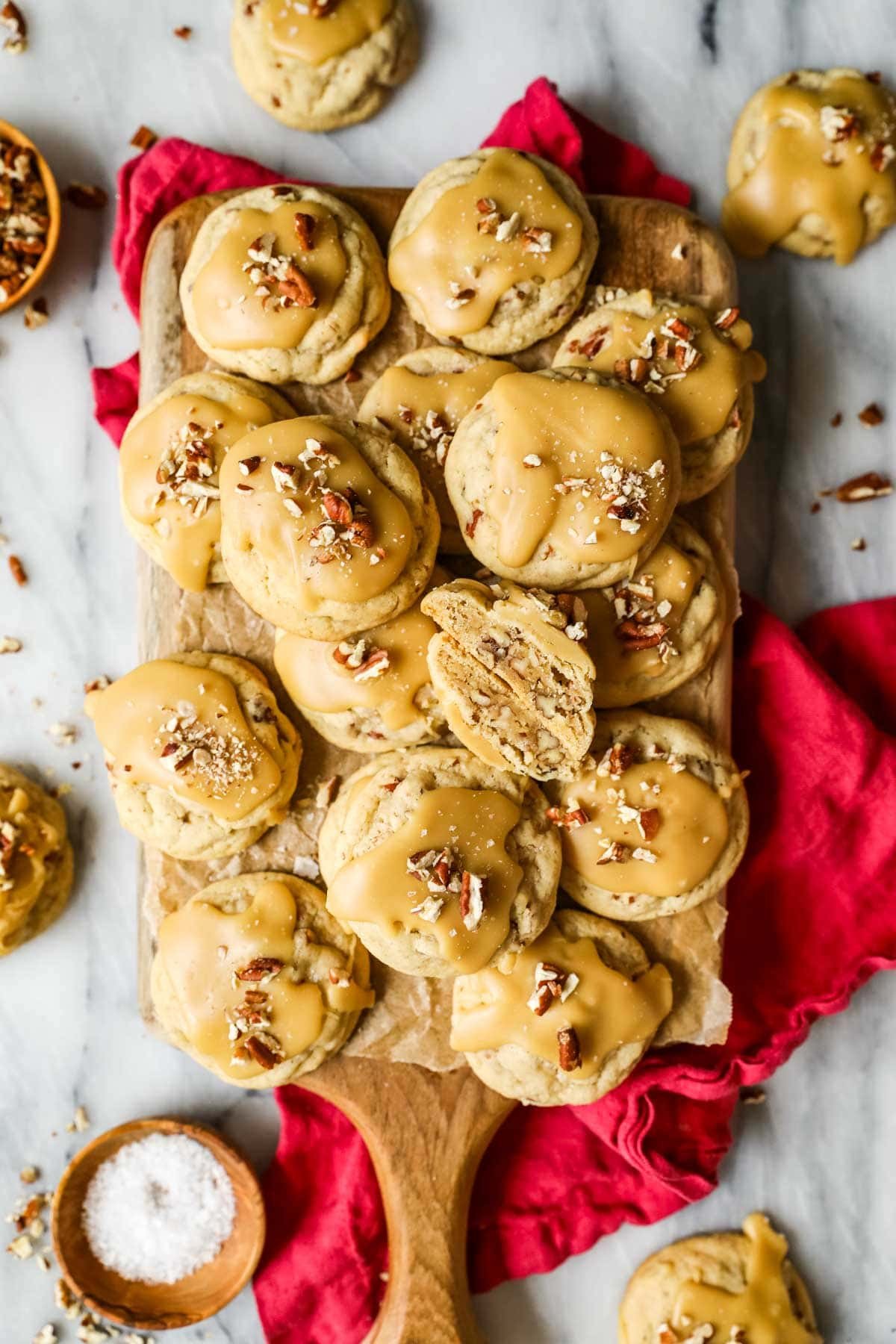 Pile of praline cookies with the center cookie cut in half to show the inside.