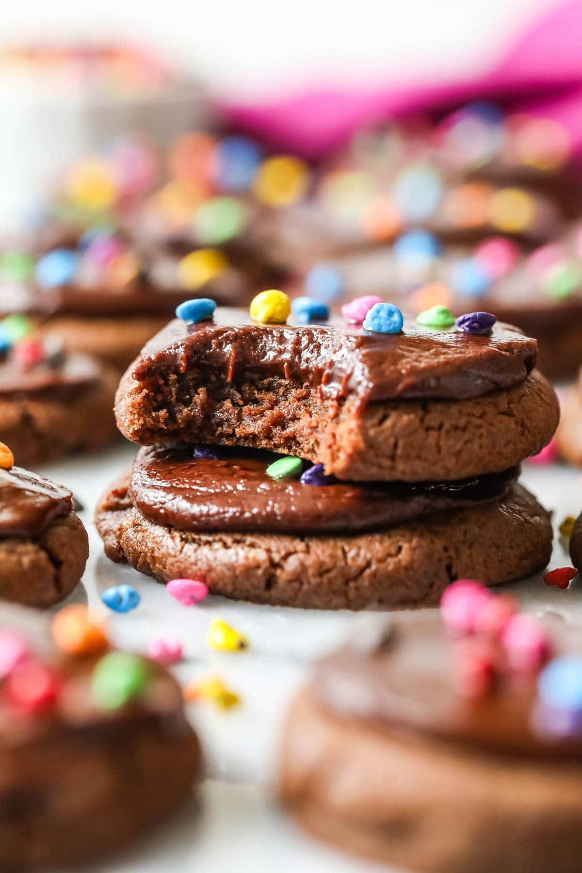 Two cosmic cookies stacked on top of each other with the top cookie missing a bite.