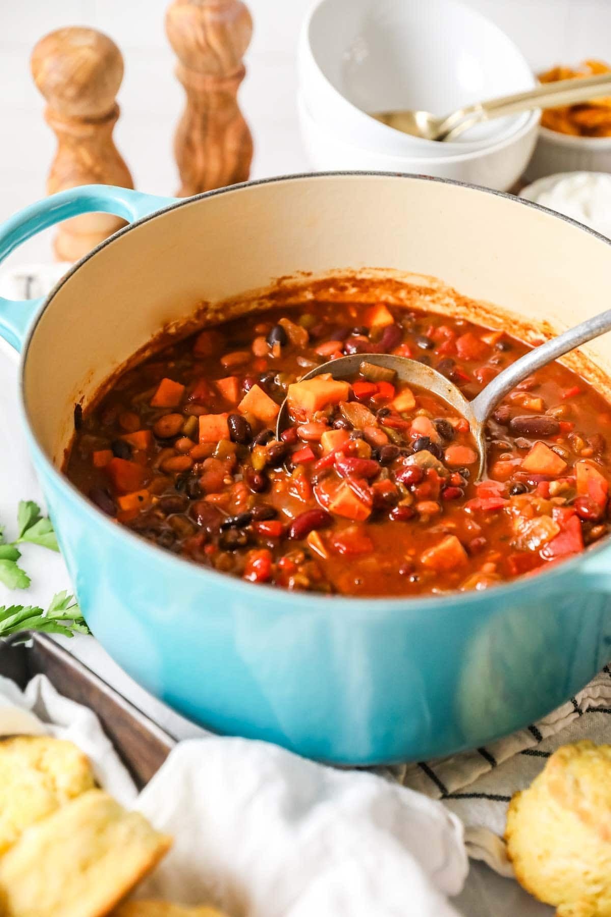 Pot of vegetarian chili made with sweet potato, beans, and more.