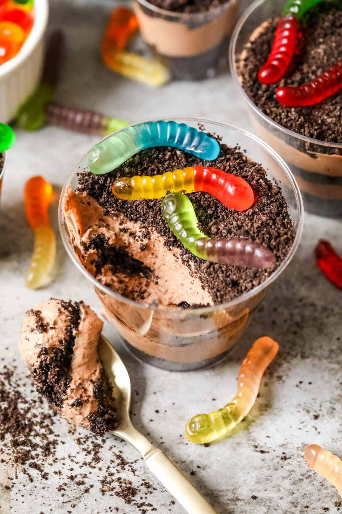 Overhead view of a cup of dirt pudding with one bite missing.
