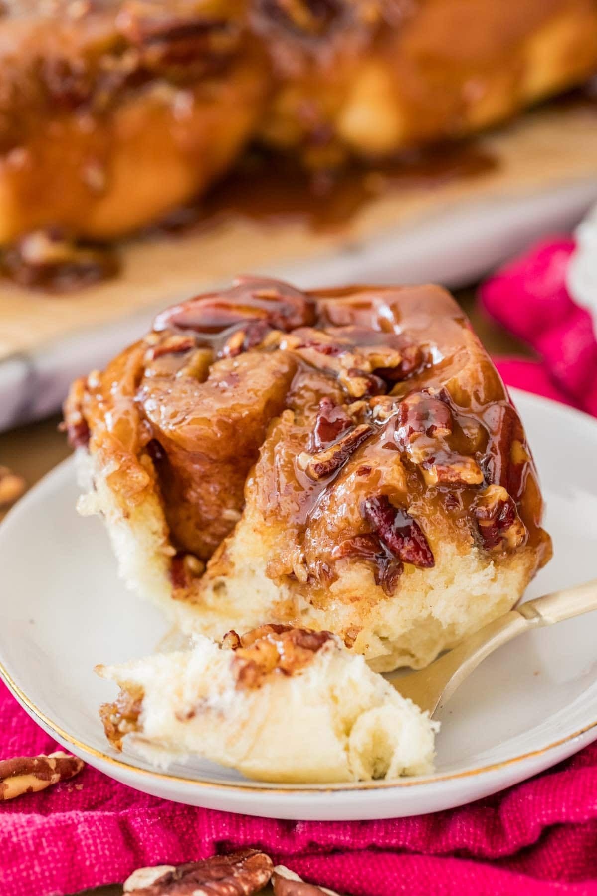 Close up of gooey sticky bun on plate.