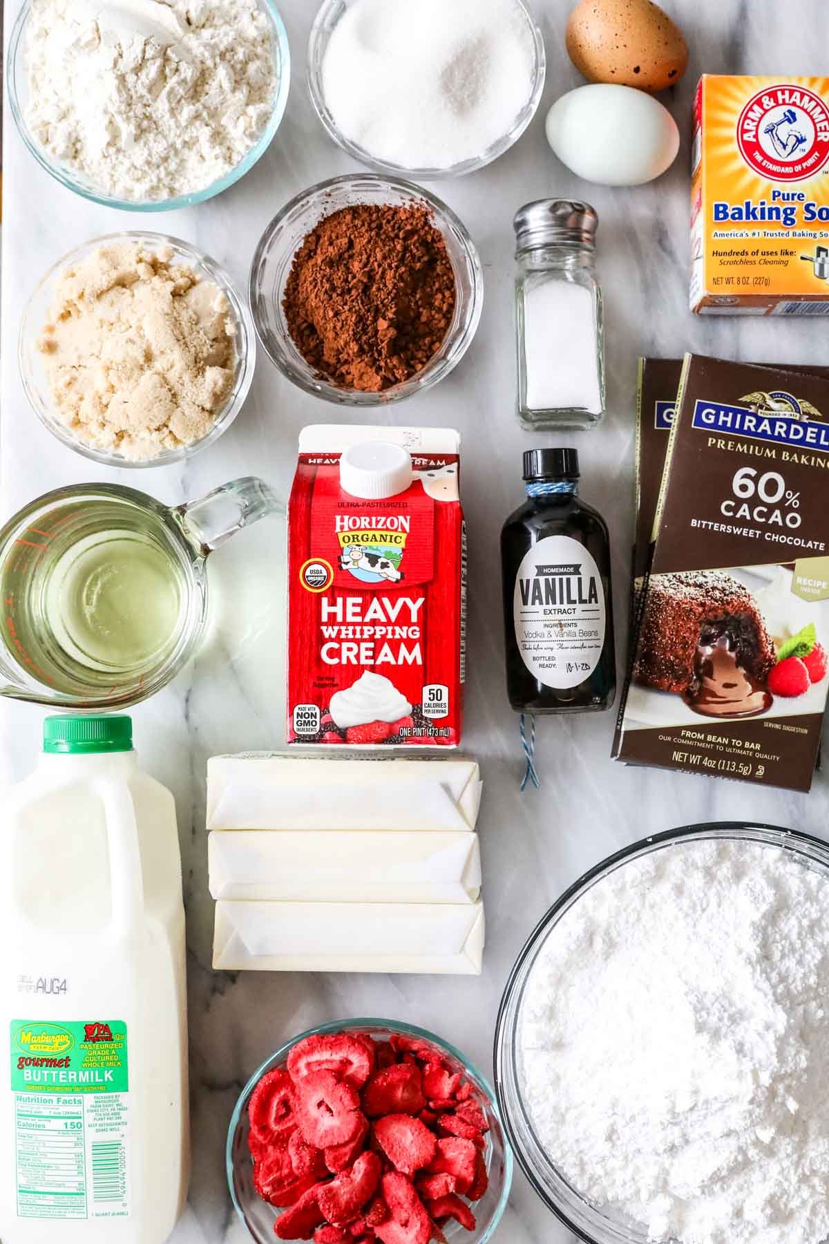 Overhead view of ingredients including chocolate, freeze dried strawberries, cream, and more.