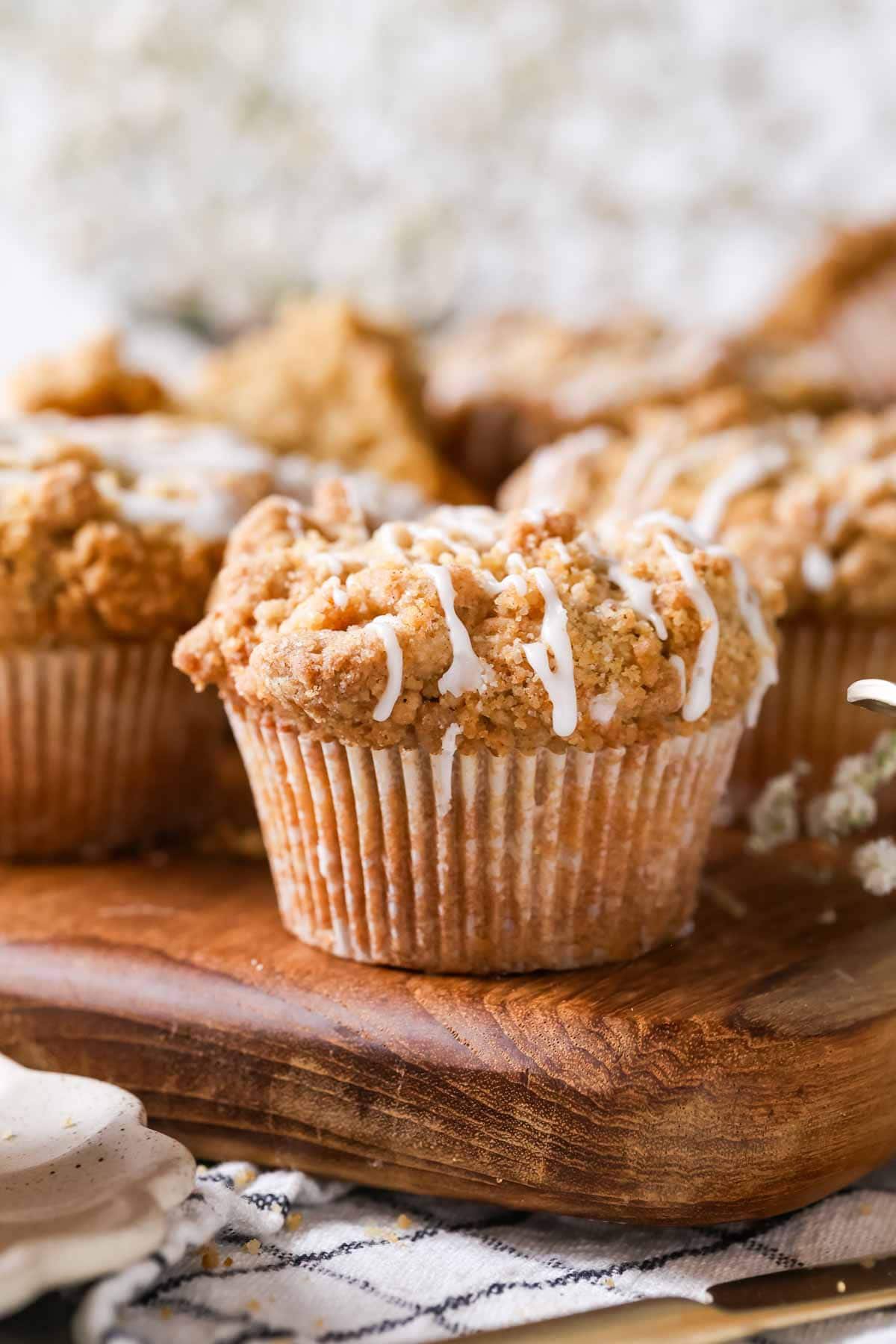 Close-up view of coffee cake muffins drizzled with a vanilla glaze.